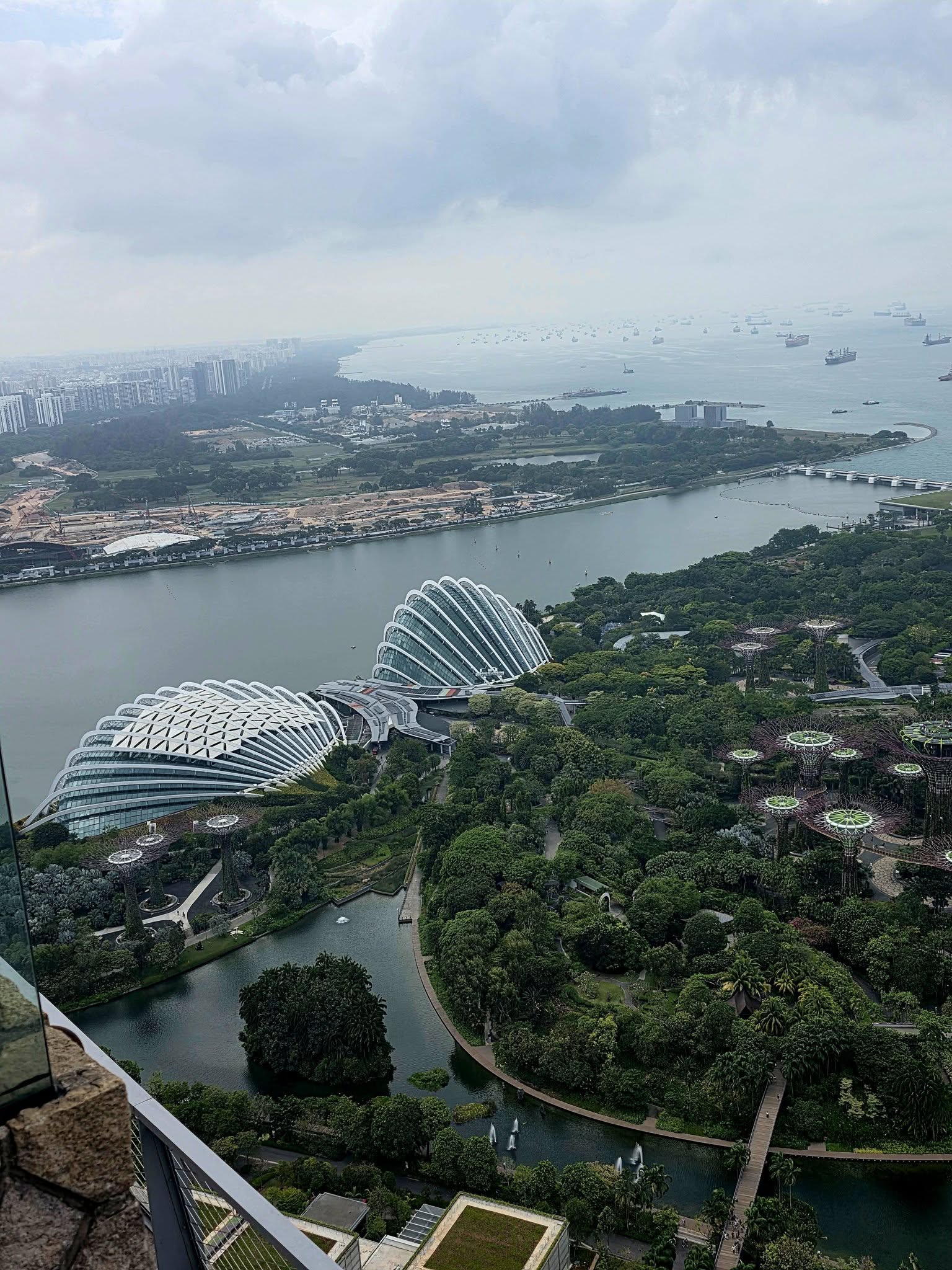 Aerial view of Gardens by the Bay with the Supertrees lit up at dusk